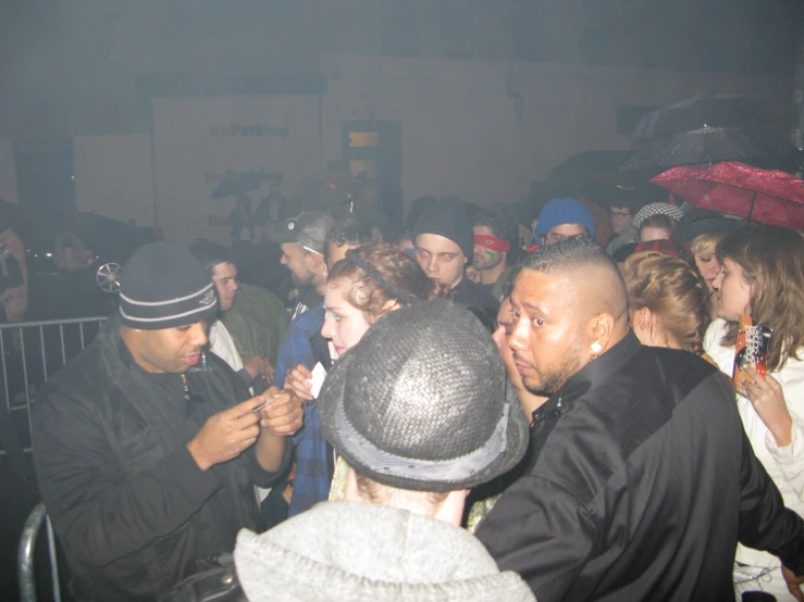 a crowd is gathered around an electronic device at a concert