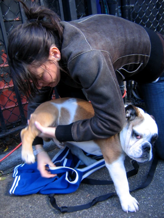 a woman kneeling down next to a dog