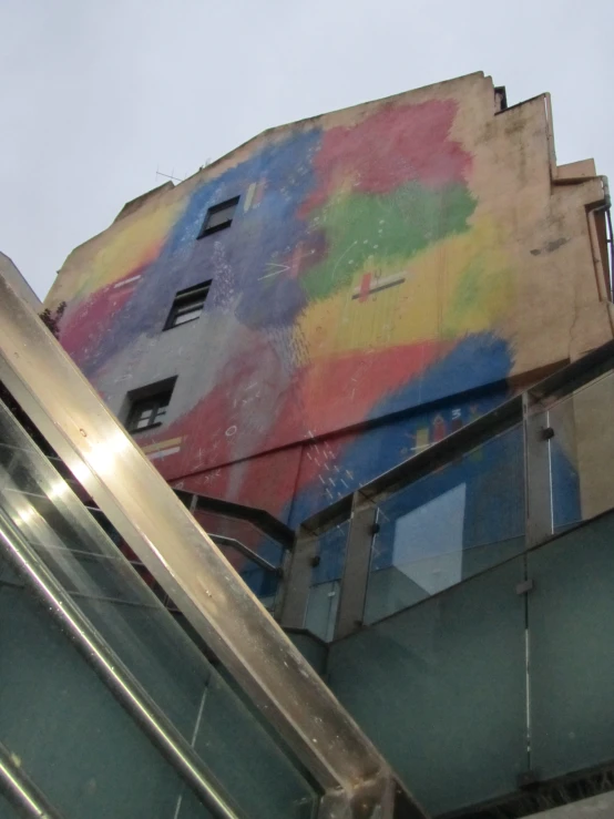 a building with a painting on it that looks like a rainbow