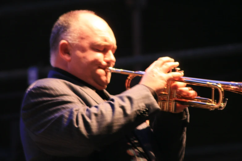 a man with an instrument in hand playing