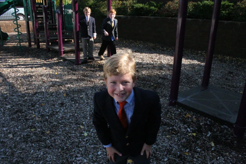 a  is smiling while wearing a suit and tie