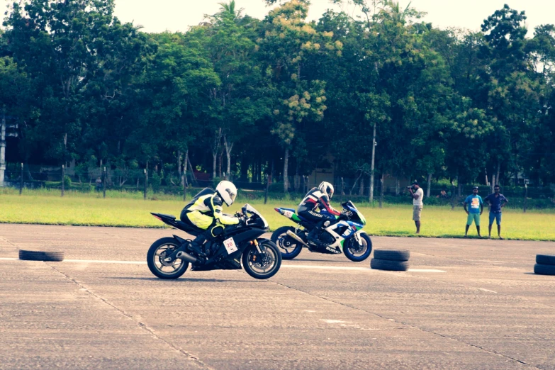 a couple of people that are racing on a motorcycle