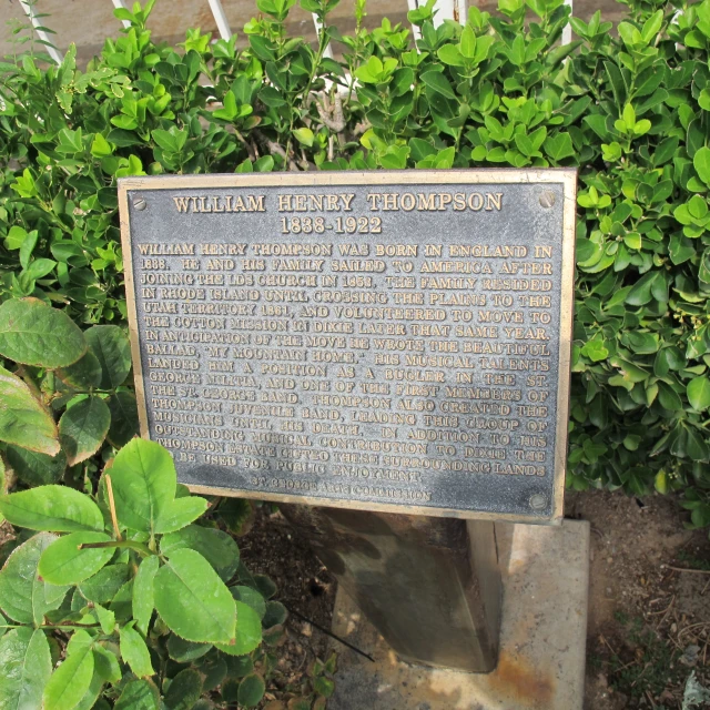 the historical marker near some bushes and shrubs