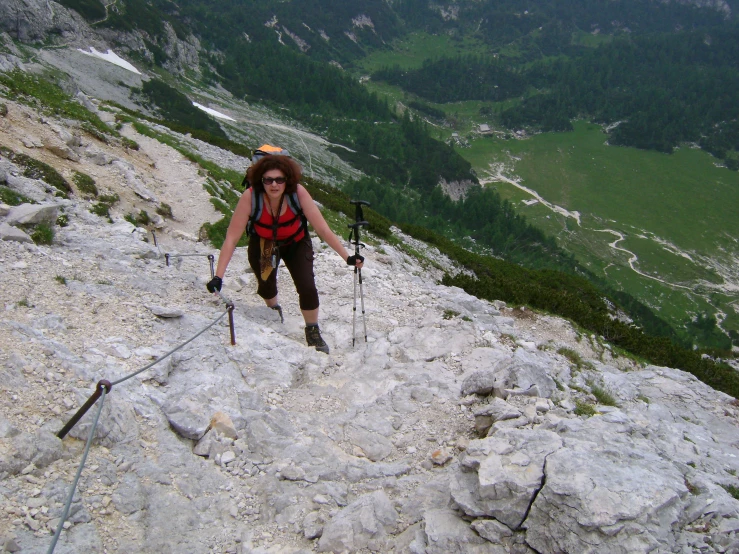 a woman hiking up a steep rocky path