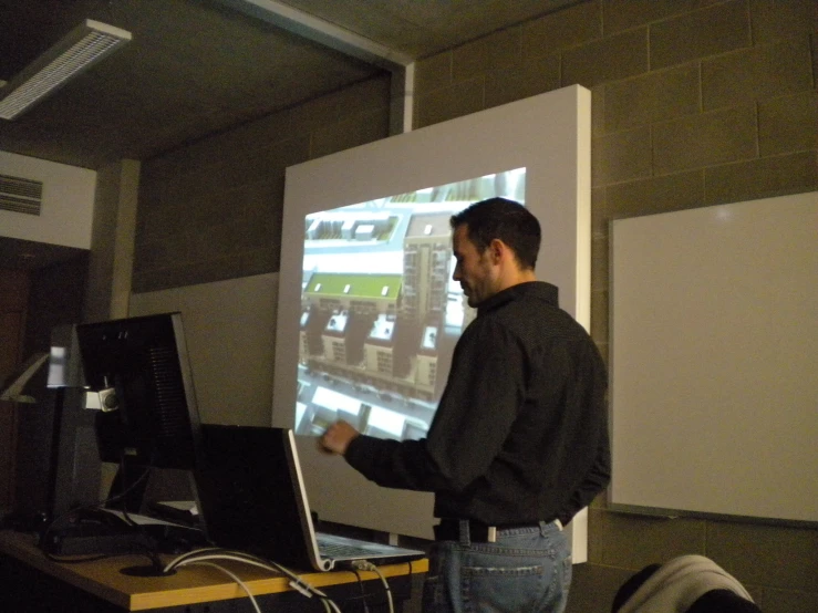 a man with a big screen display in the middle of his room