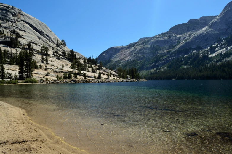 a lake surrounded by mountains with clear water