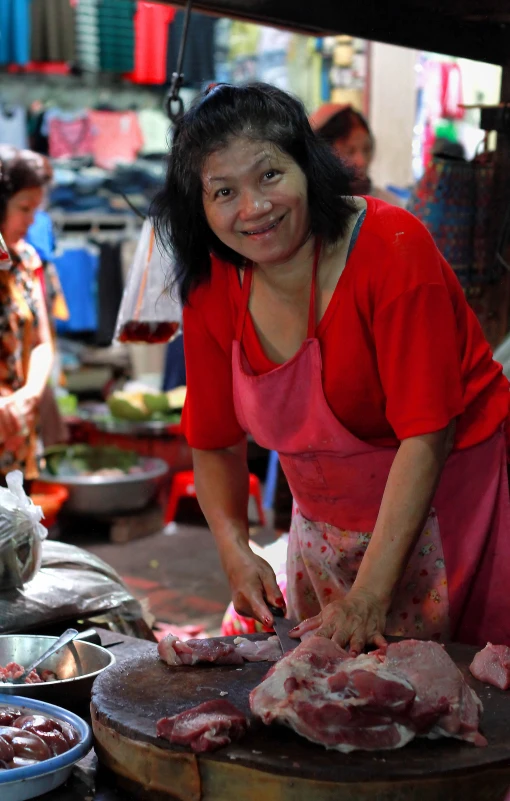 a woman is  up food while smiling