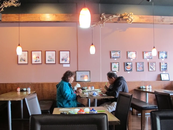 a man and woman sitting at a table together