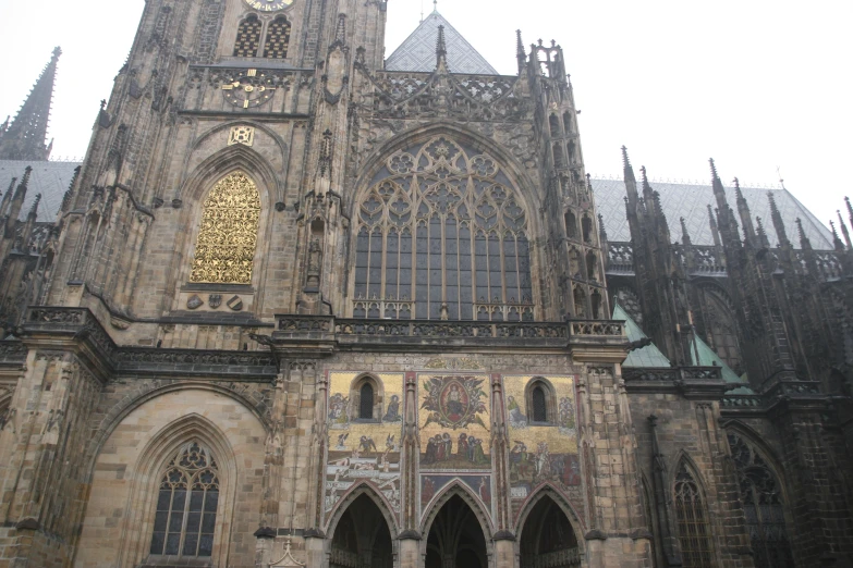 a cathedral with a clock tower and a very large window