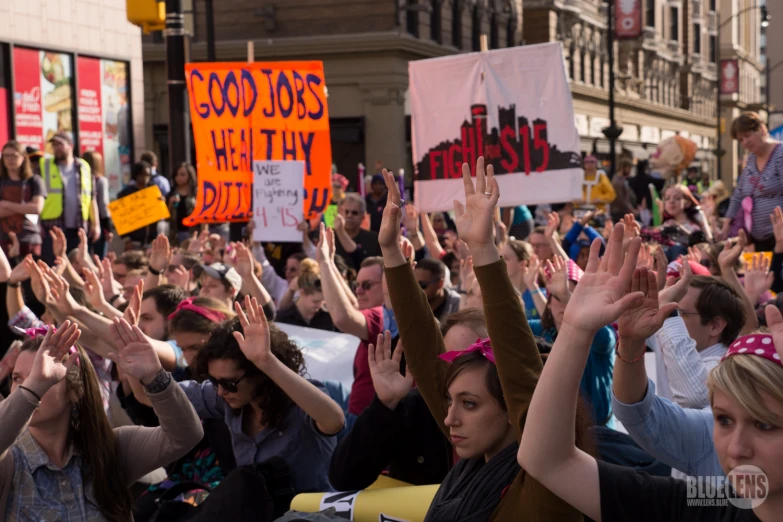 large group of people in a city holding signs