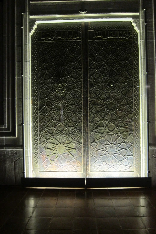 a large glass door with an intricate pattern