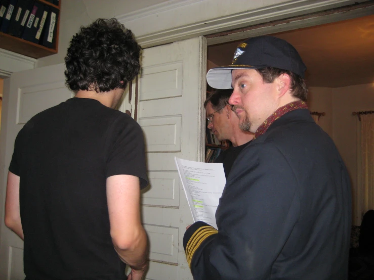 a man in navy uniform in front of a door