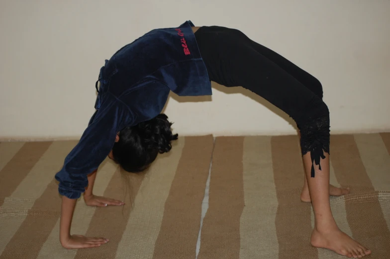 a woman bending down on one side on top of a bed