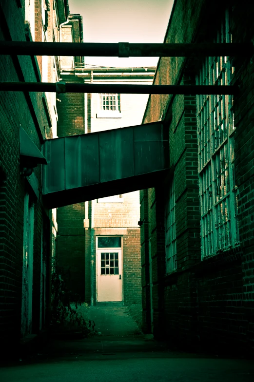 a long alley with a gate in the middle of it