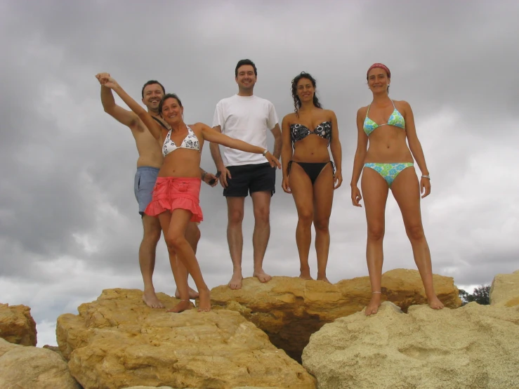 a group of people standing on top of rocks