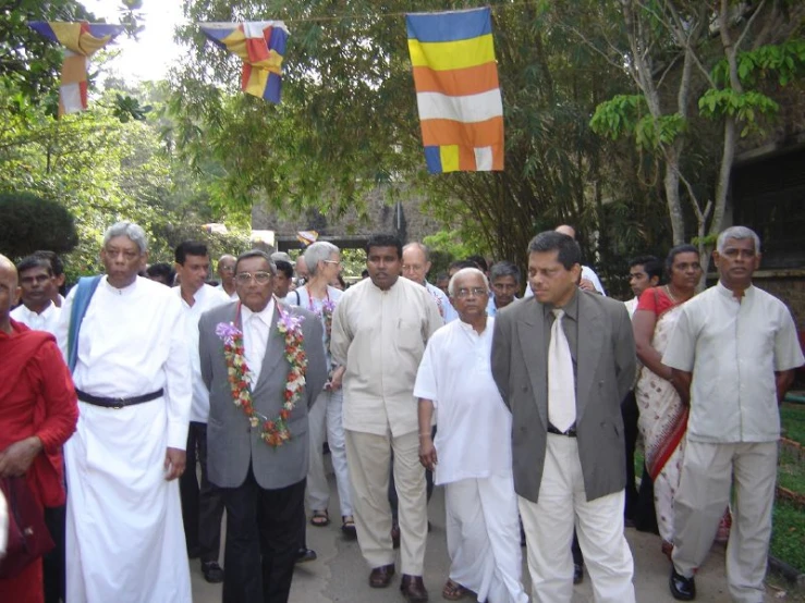 a group of men walking together on a sidewalk