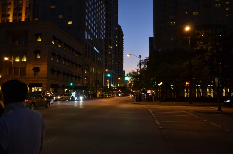 a dark street and buildings is dimly lit