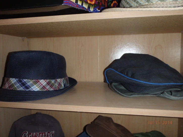hats are lined up in shelves, one is a blue hat