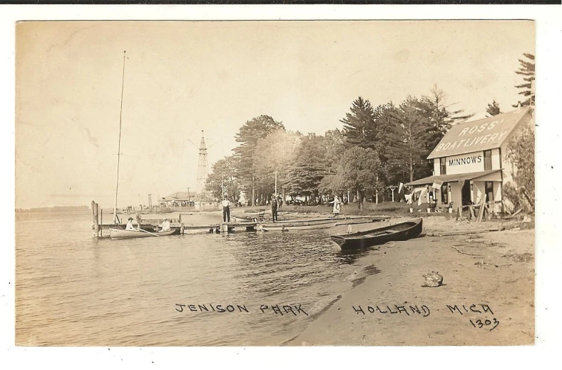 a sepia po of people on a beach near boats