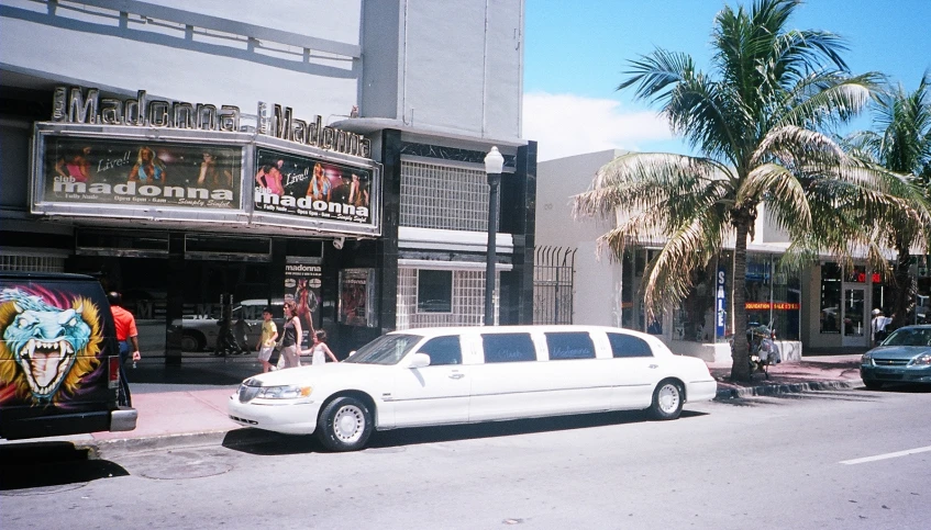 white limo parked on the side of the road