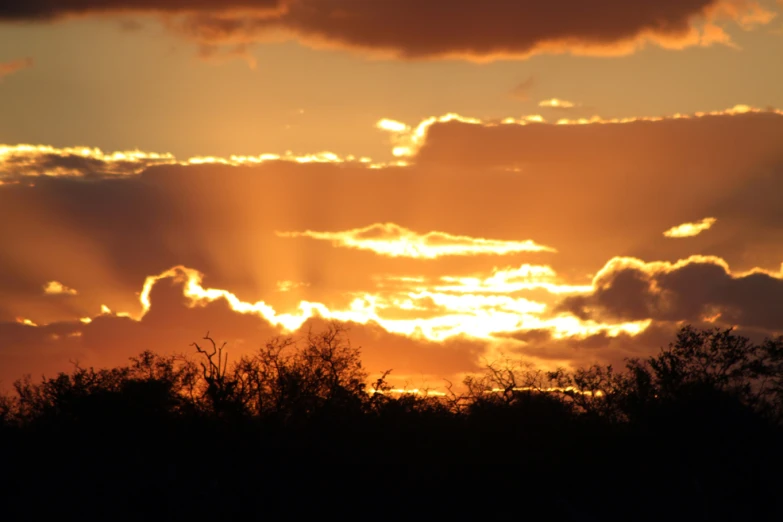 sun peeking through the clouds that are in the sky