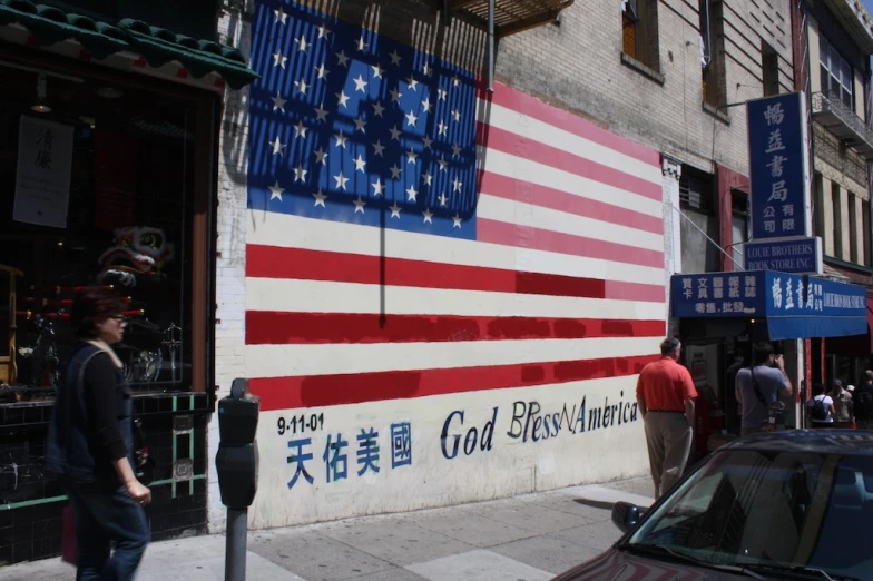 a american flag painted on the wall on a city street