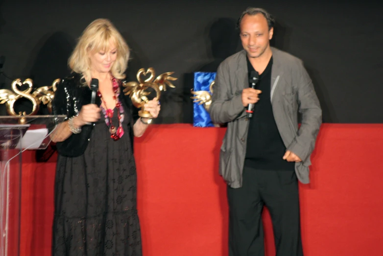 a man and woman at a podium with microphones