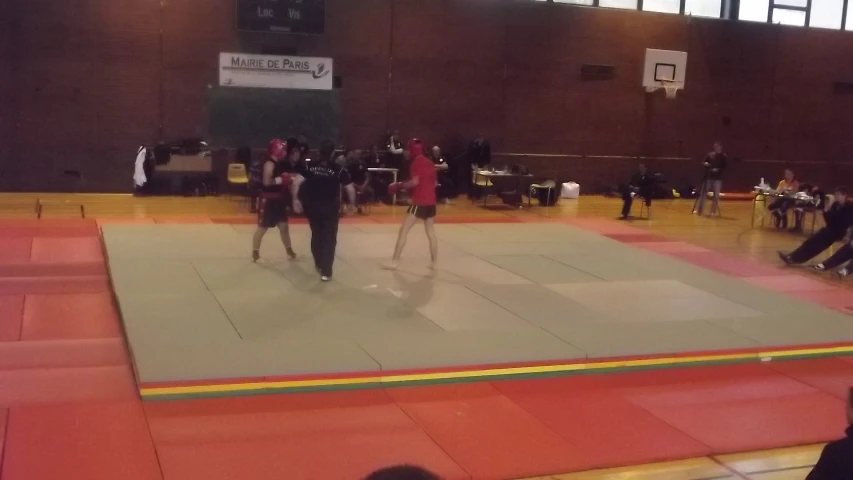 two women dancing on a large basketball court