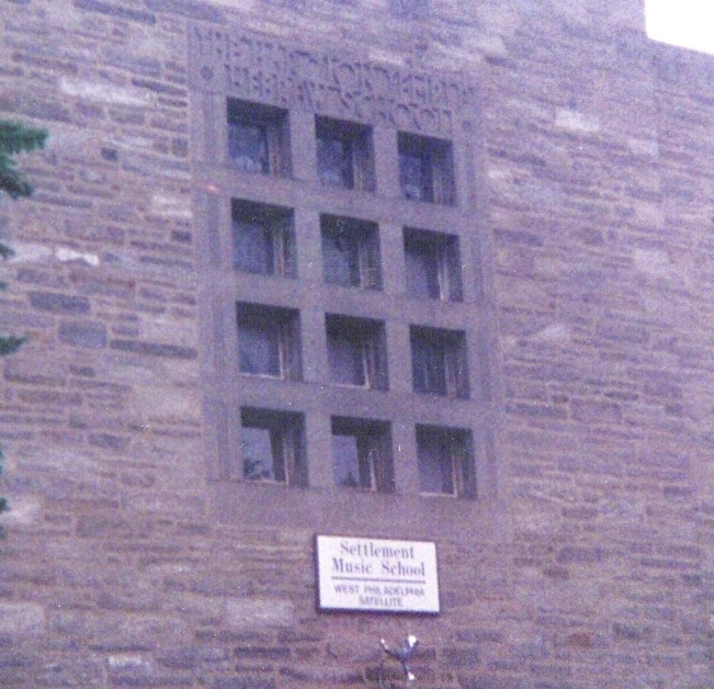 the front facade of a building with large windows