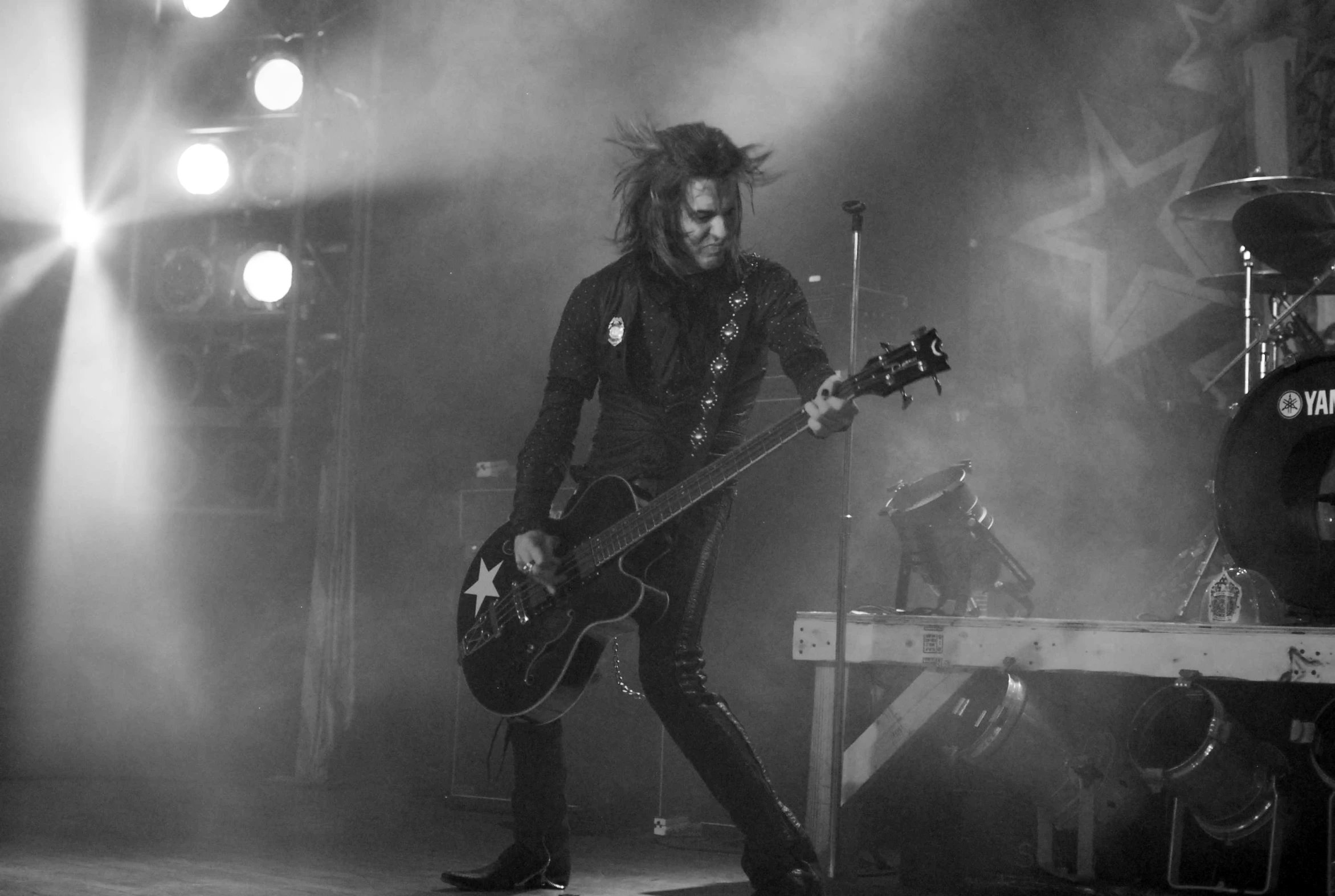 black and white po of young man playing guitar at a concert