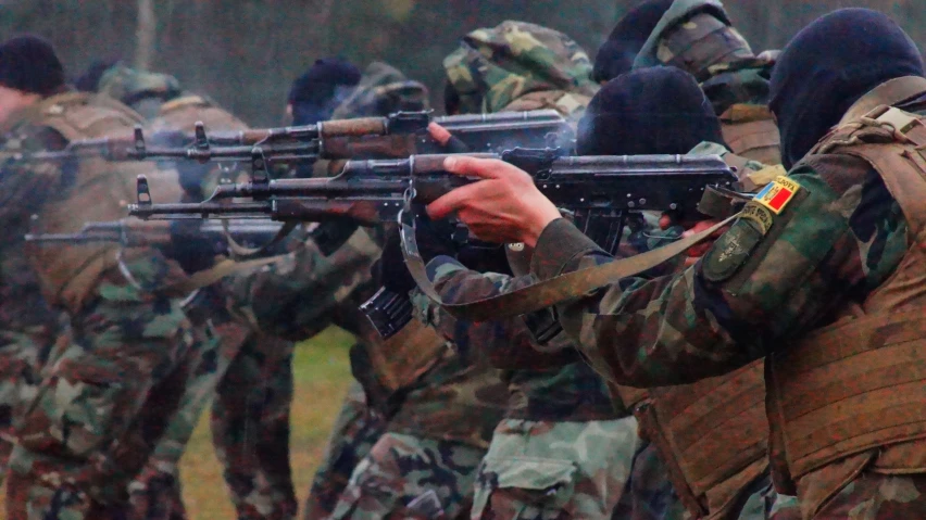 several soldiers with gun in a row