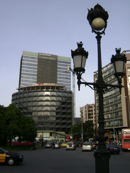 a street lamp next to several buildings and a taxi car