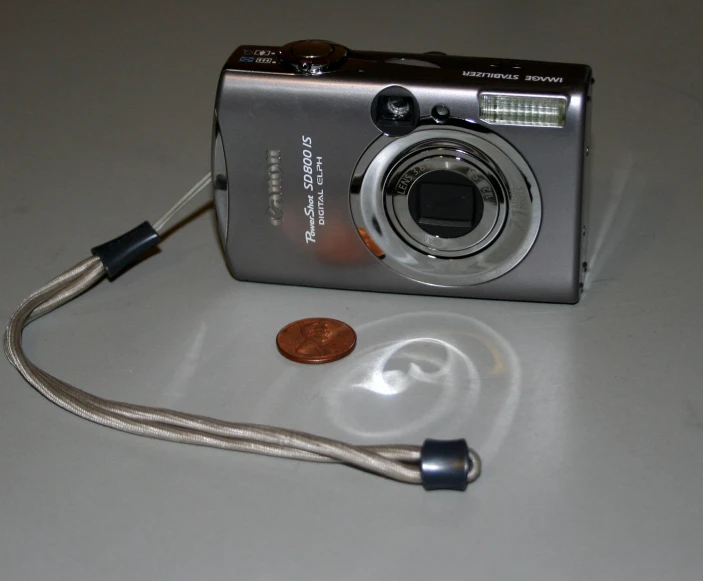 the digital camera is next to a charger