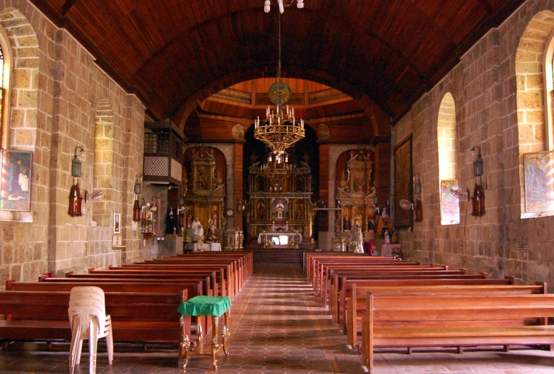 a room full of wooden benches in a church