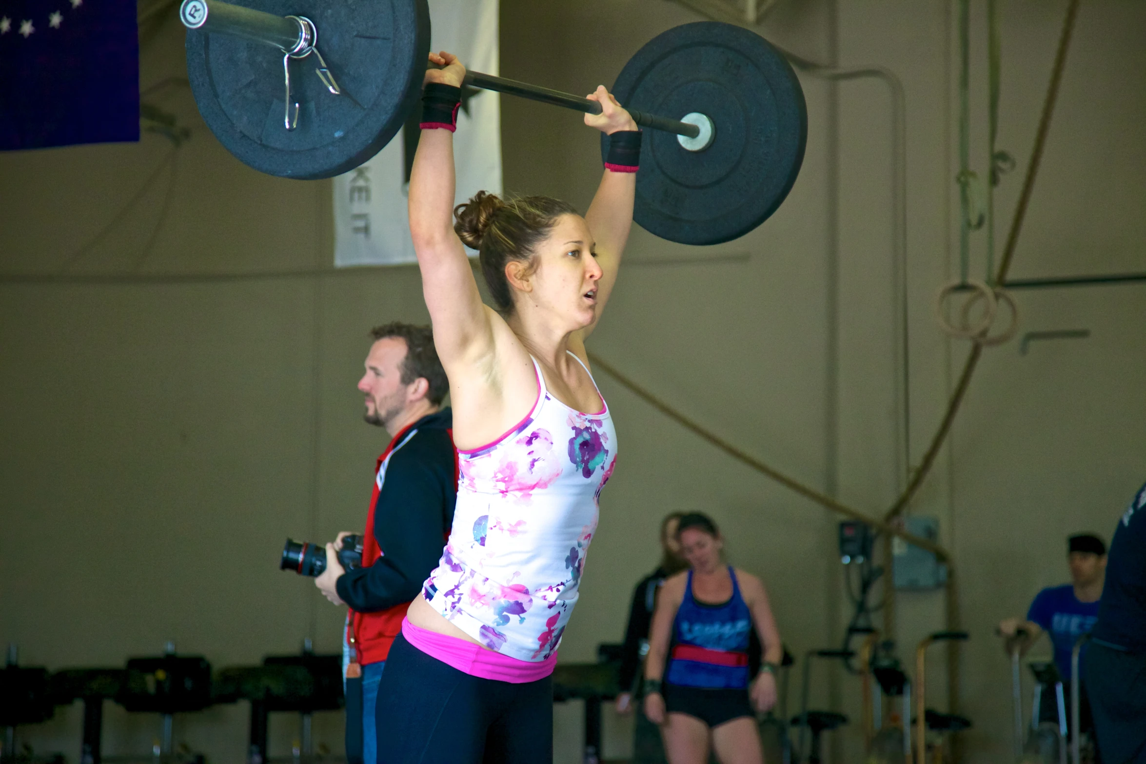 a woman doing squats in front of a group of people