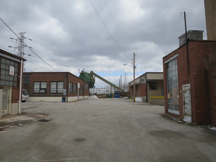 an industrial area with broken down buildings, a crane and other appliances