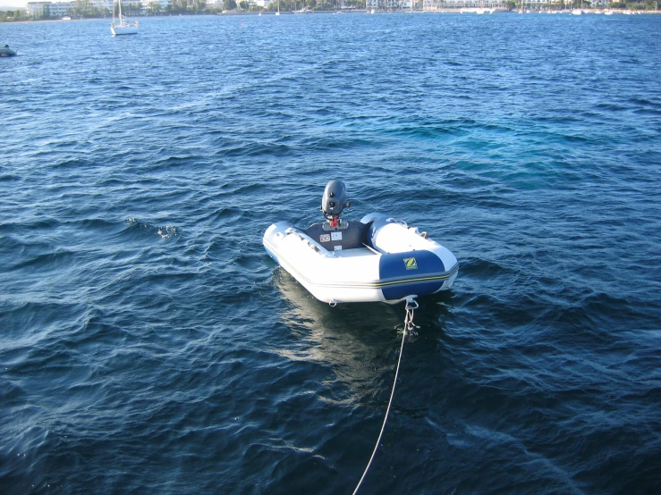 a small boat is tied up in the water