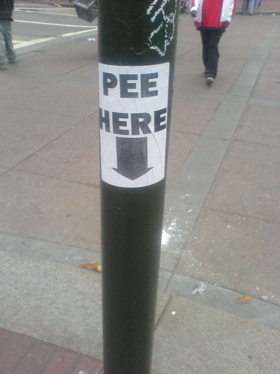 the street side shows the pole on the right with a pee here sticker taped to it