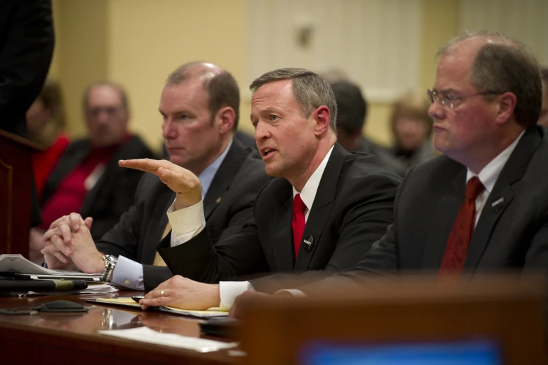 two men sitting at a meeting table talking