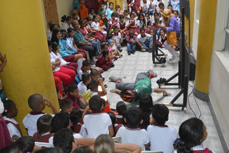 children are gathered around watching an event