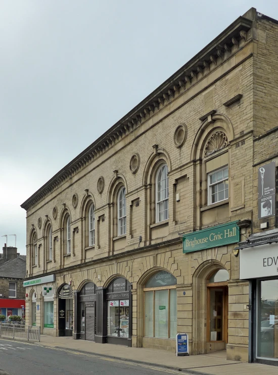 a city street corner with businesses along one side and shops on the other side