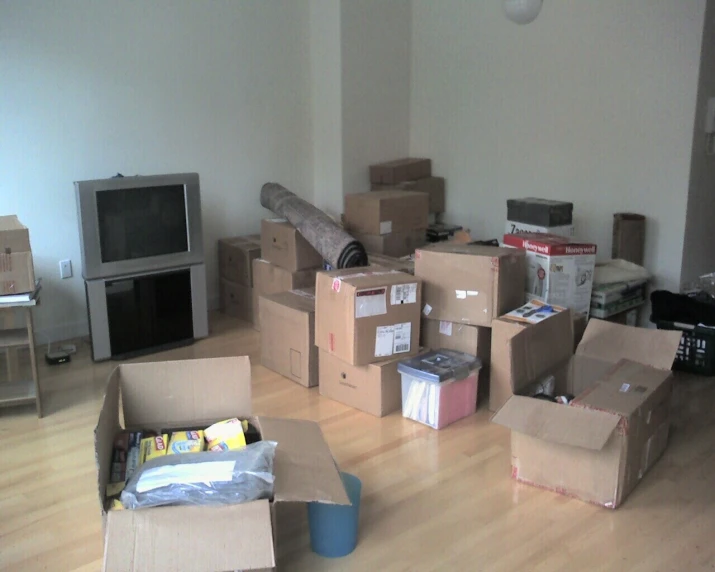 a very large group of boxes and furniture in a room