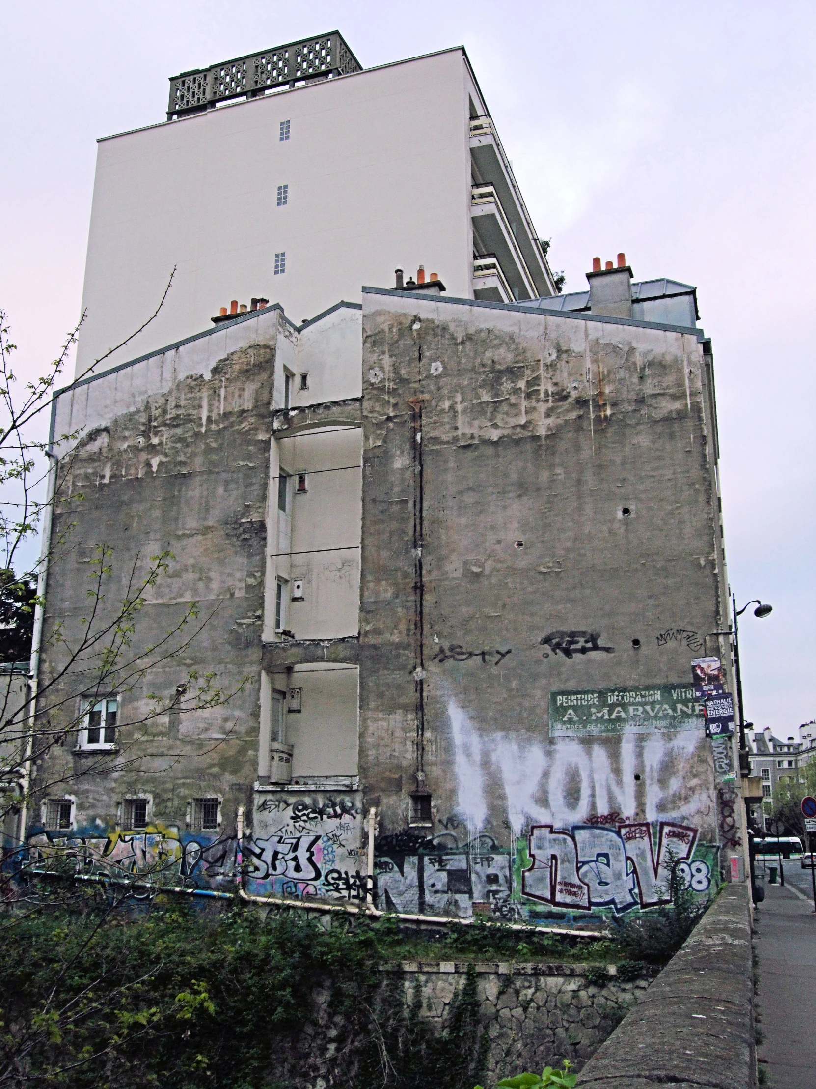 graffiti covered building with power lines on one side