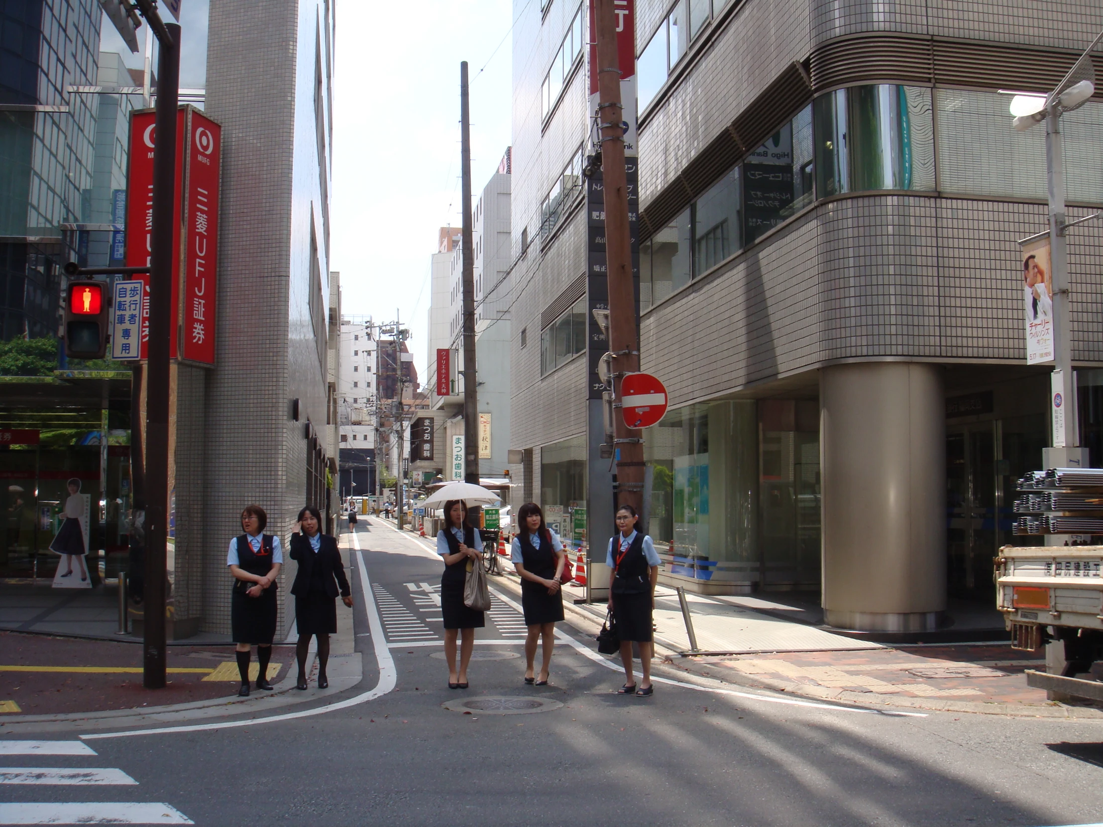 a group of people crossing a cross walk