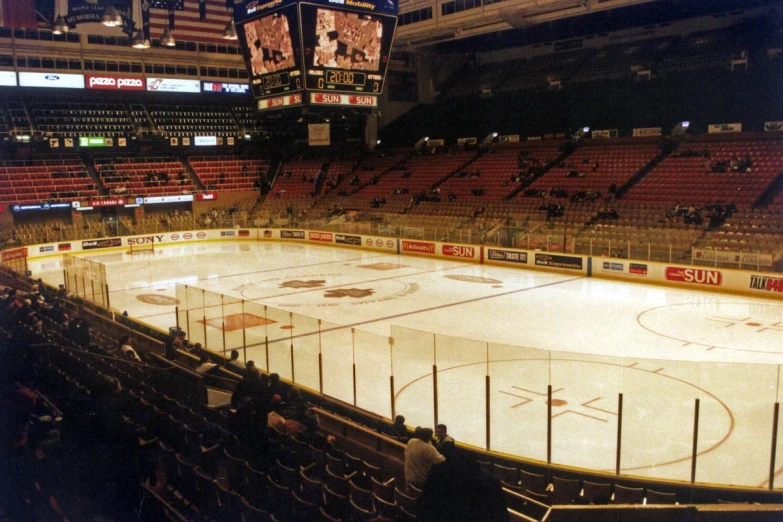 a hockey arena full of seats with a hockey field