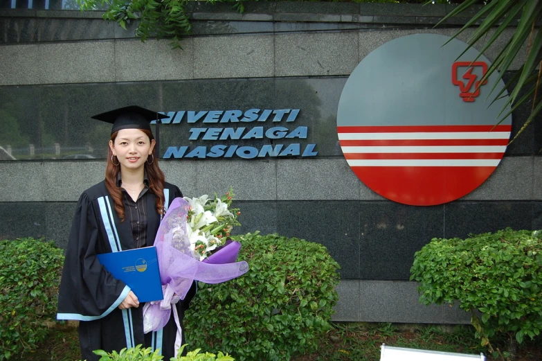 woman standing outside a building with flowers in front