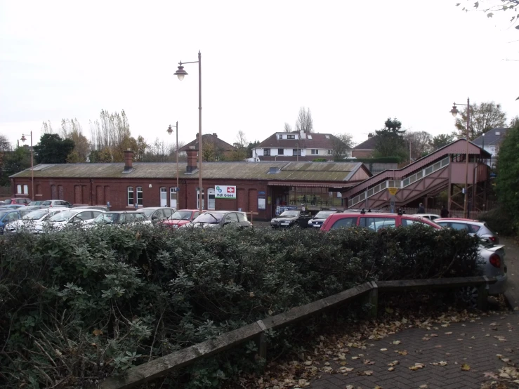 cars are parked outside an old red brick building