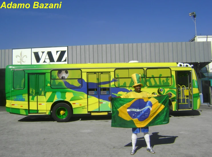 a person is holding up a flag in front of a bus