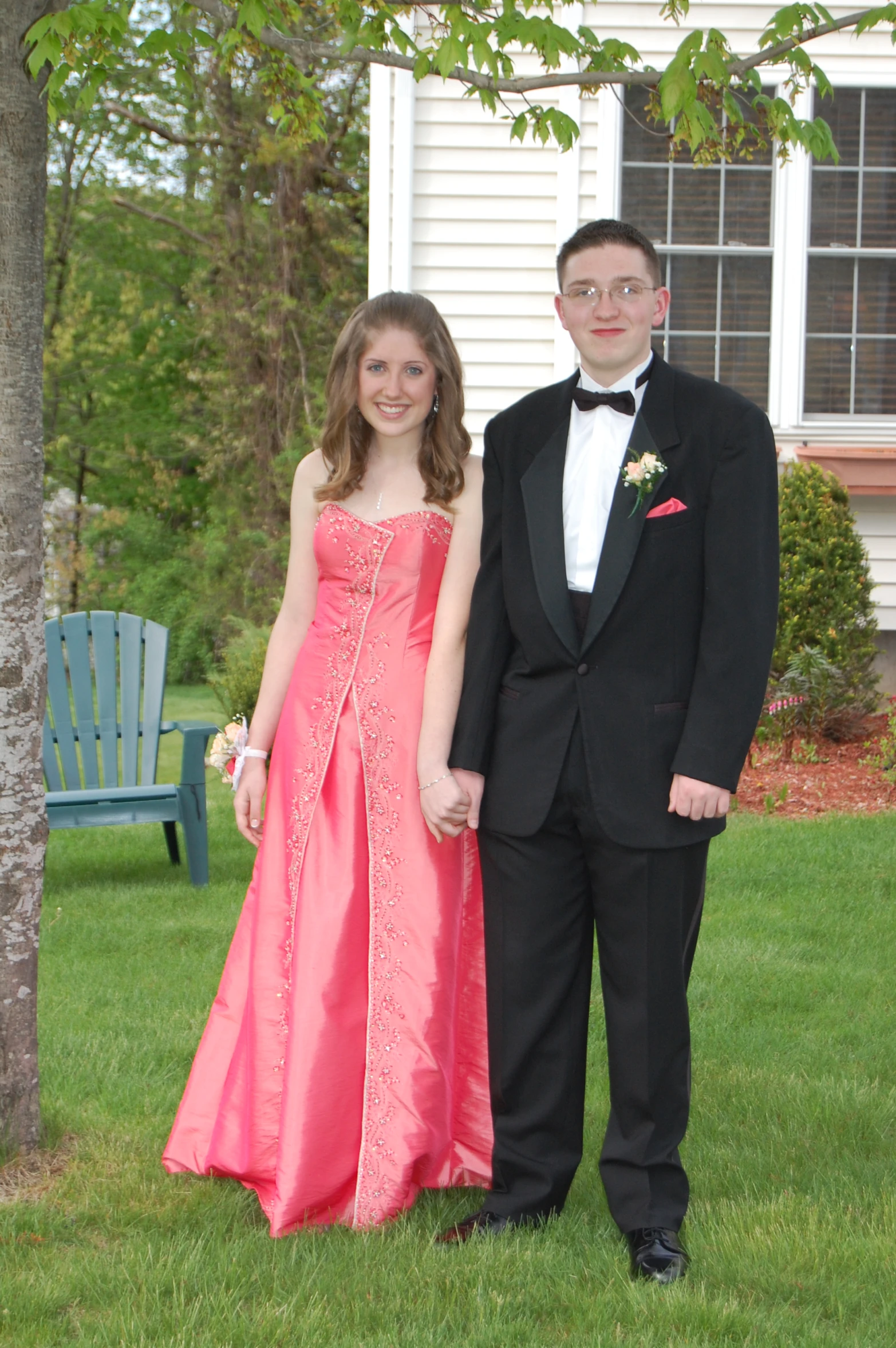 two young adults dressed in formal attire standing together