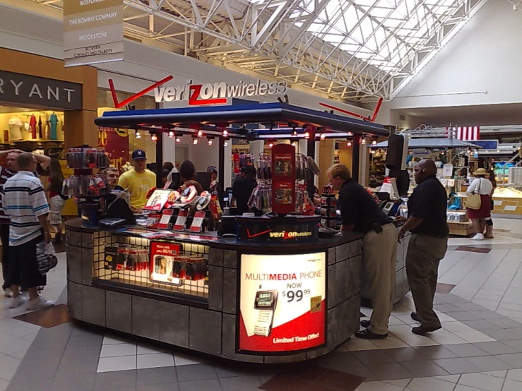 people in an airport looking at items in a checkout stand